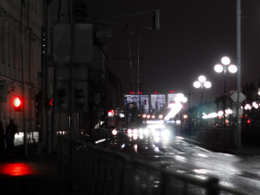 a city street filled with lots of traffic at night