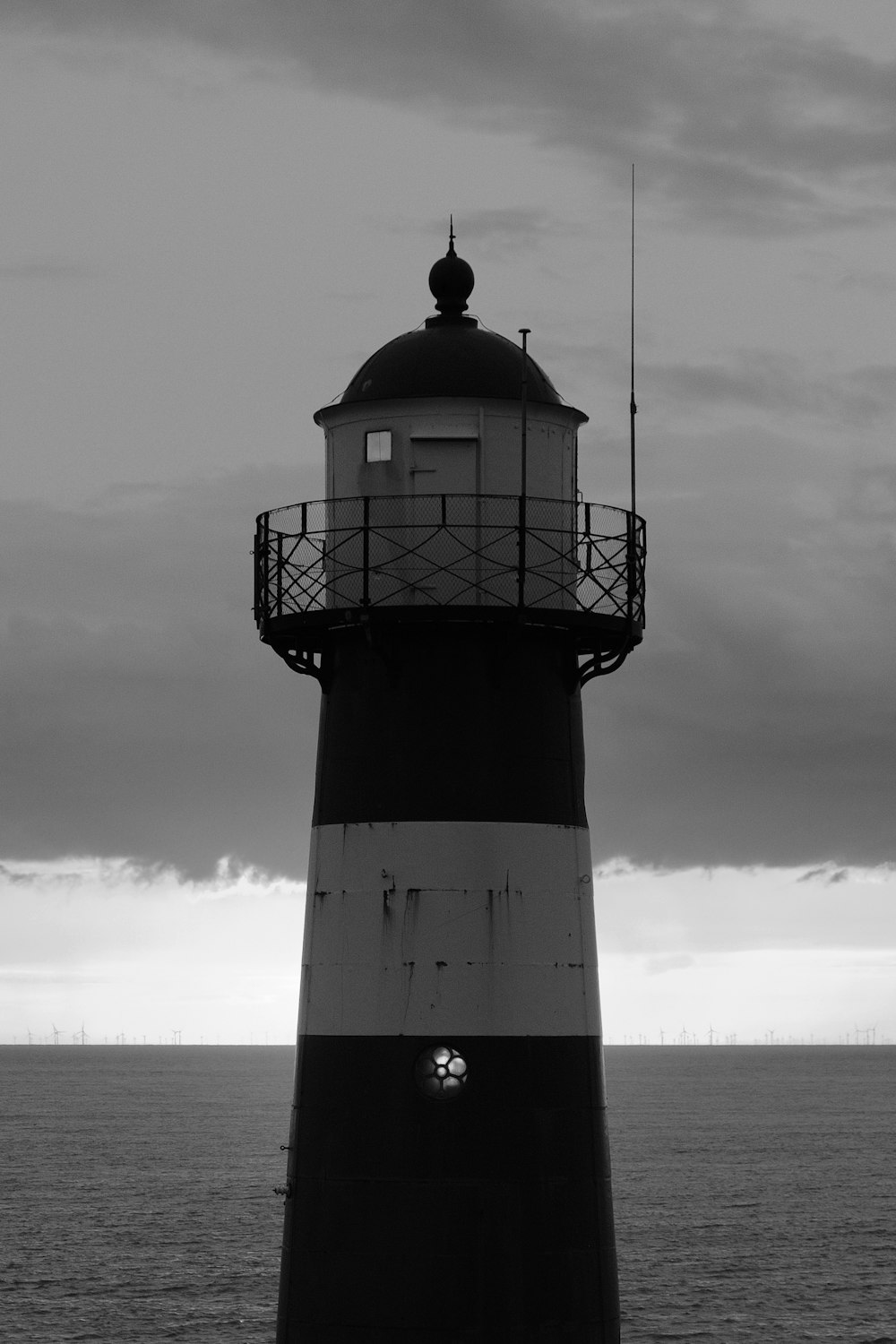 a black and white photo of a lighthouse
