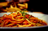 a plate of spaghetti with tomato sauce and parsley