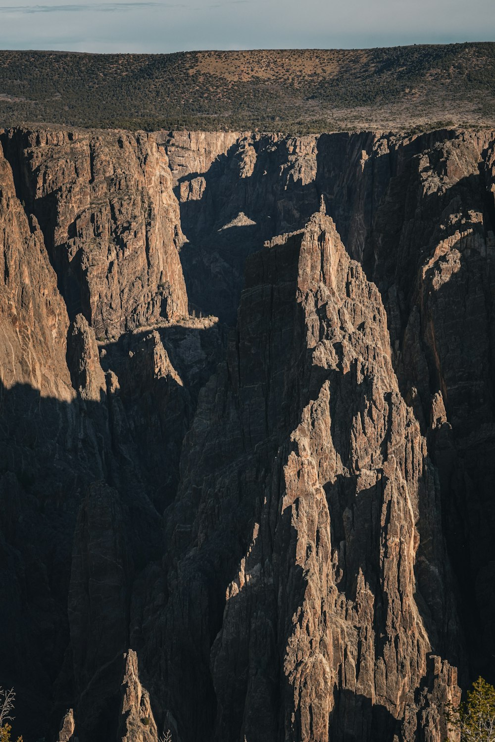 a view of a canyon with a mountain in the background