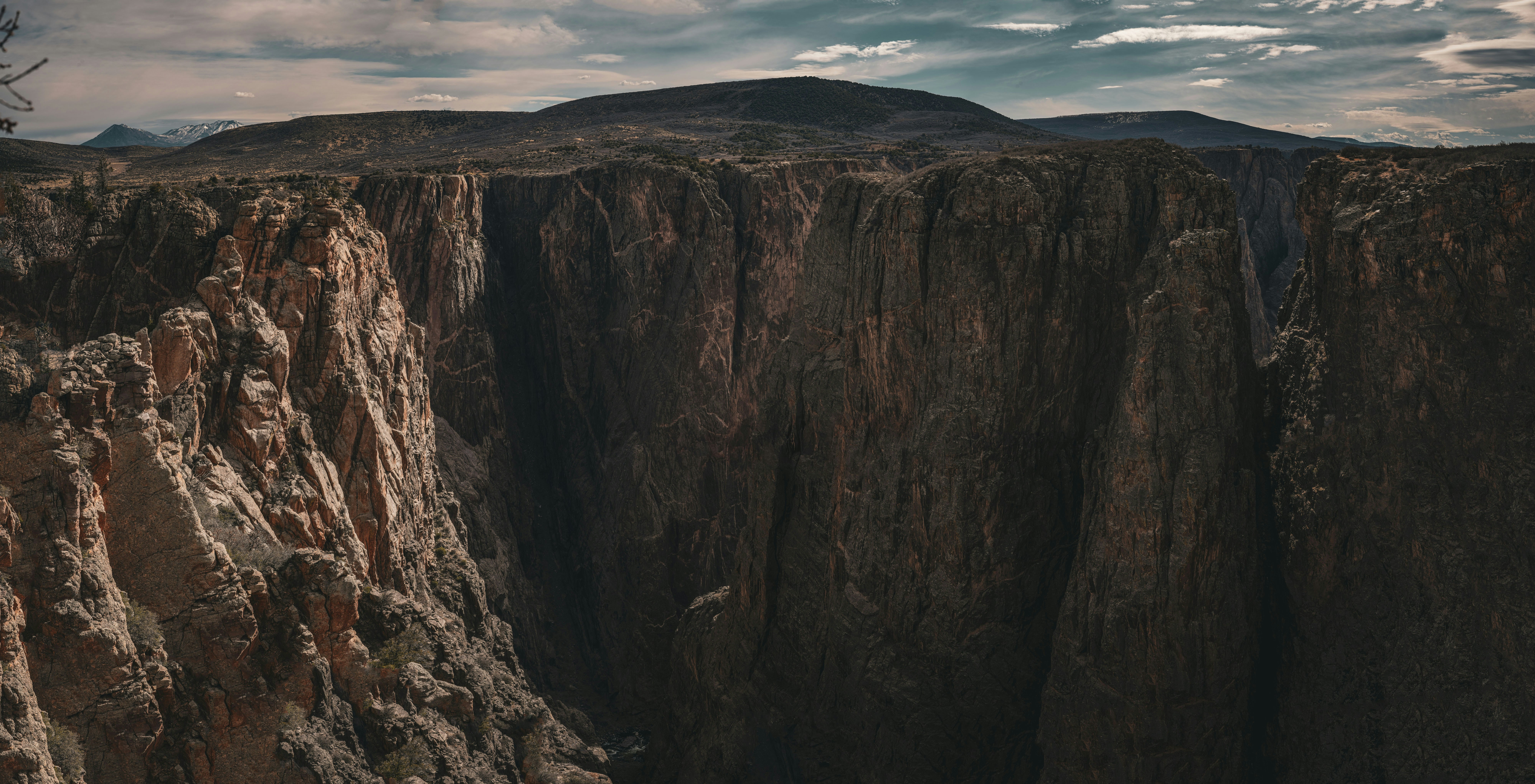 a view of a canyon with a mountain in the background, 