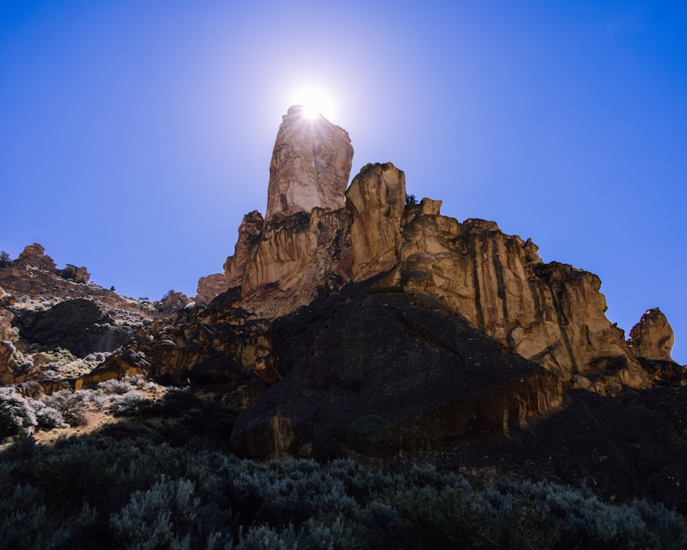 the sun shines brightly on a rocky outcropping