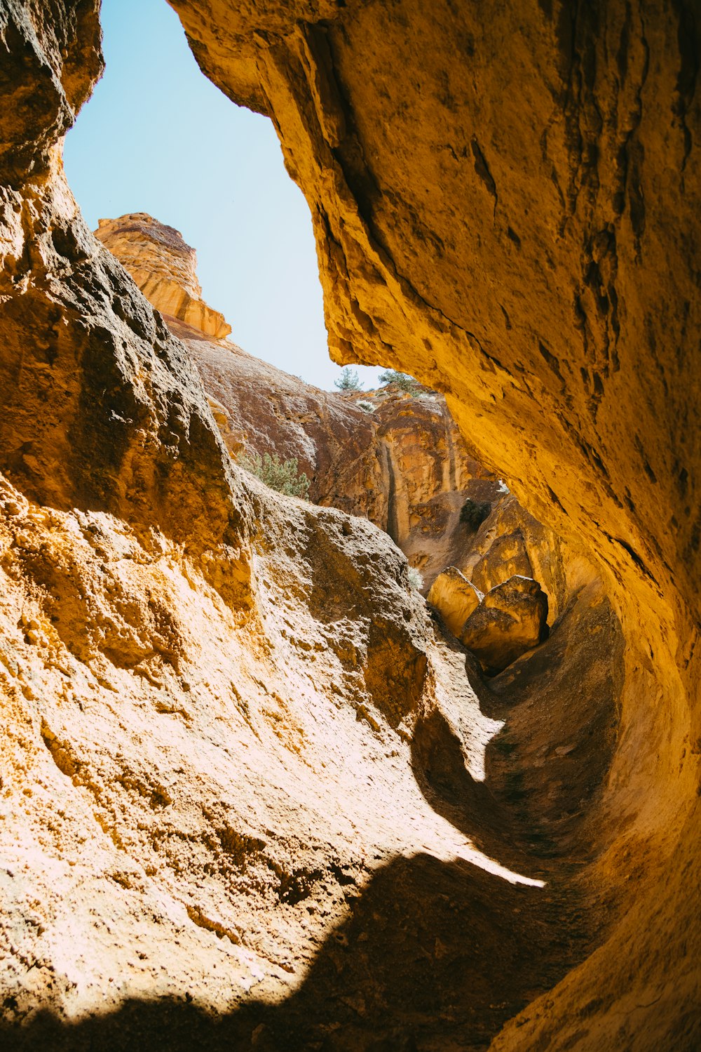 a view of a rock formation through a narrow opening