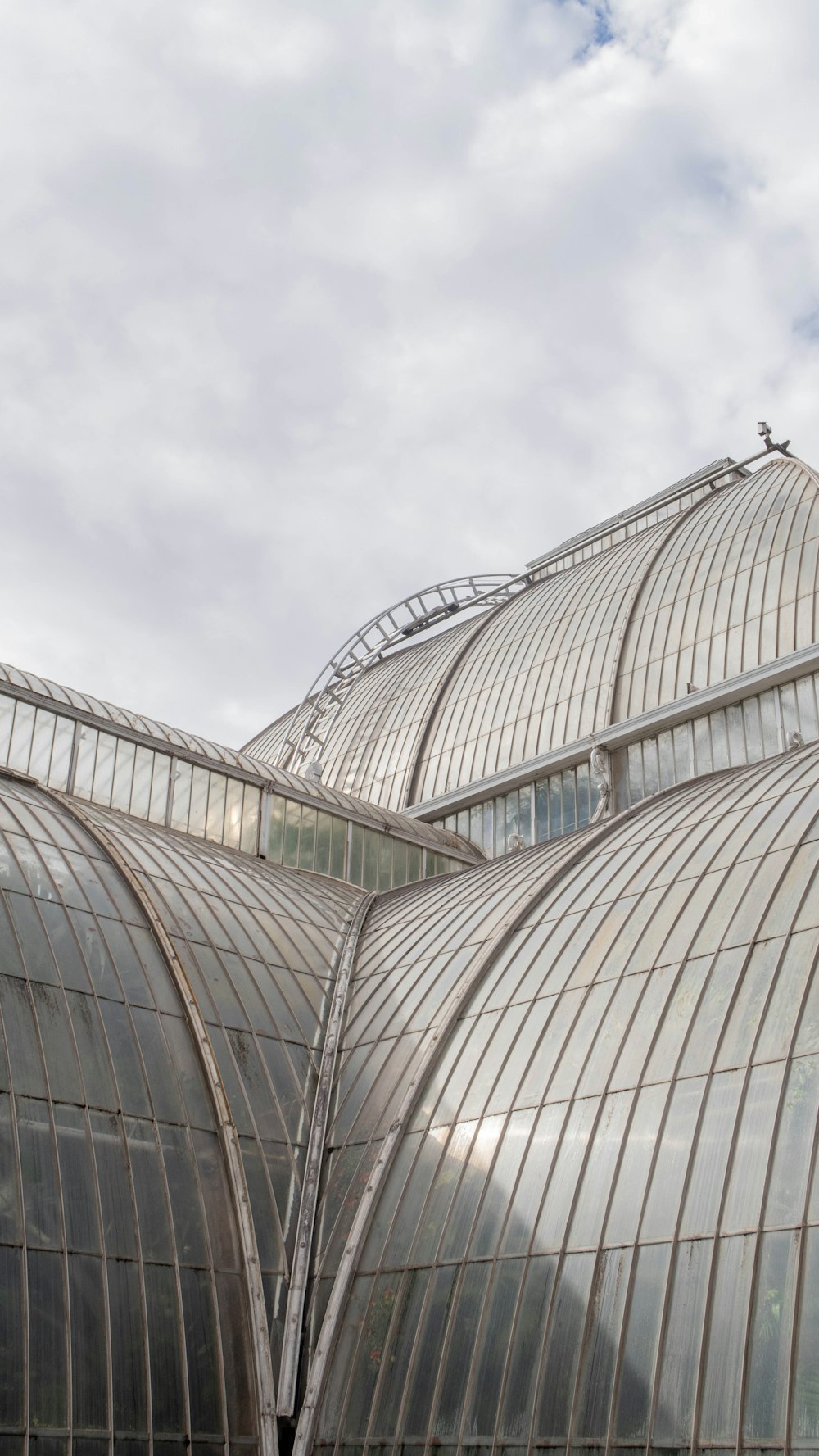 a couple of large glass buildings with a sky background