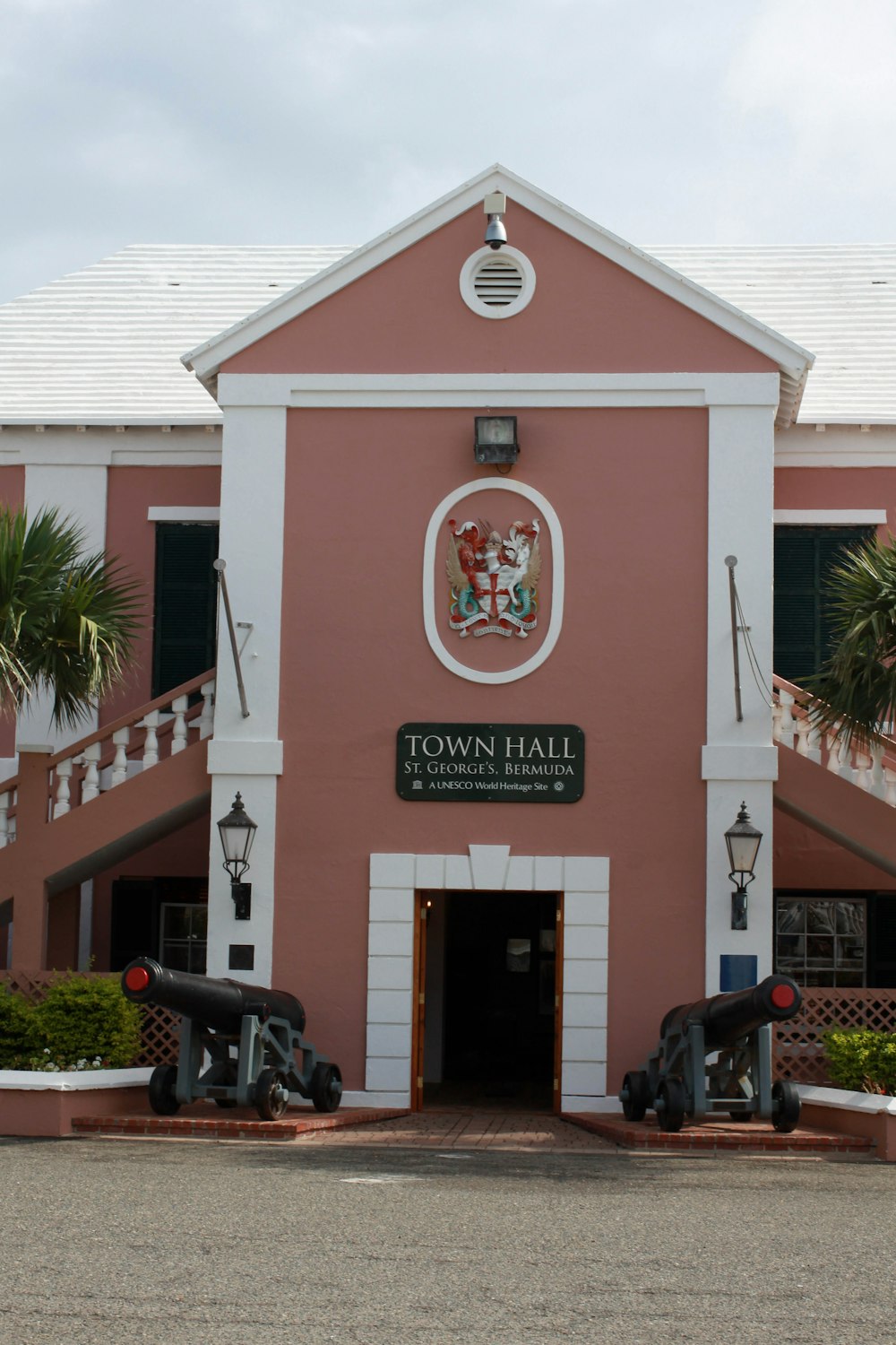 a pink building with a sign that says town hall