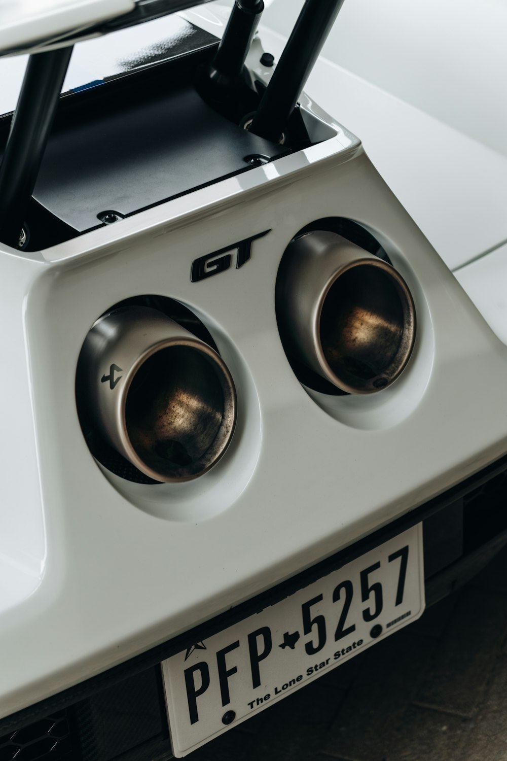 a close up of a white car with two speakers