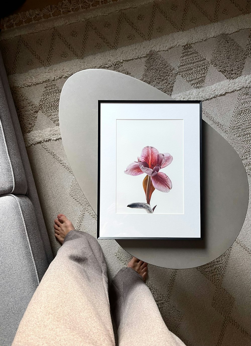a picture of a pink flower in a white frame