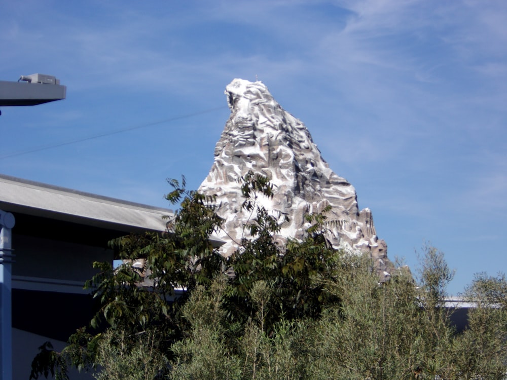 a very tall mountain with trees in front of it