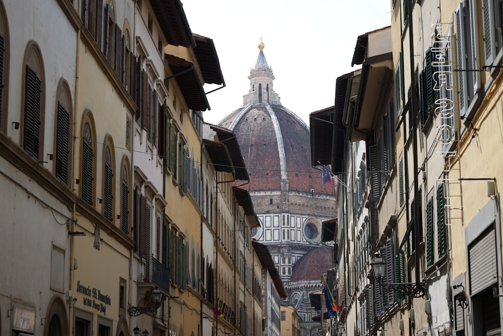 a city street with buildings and a church in the background