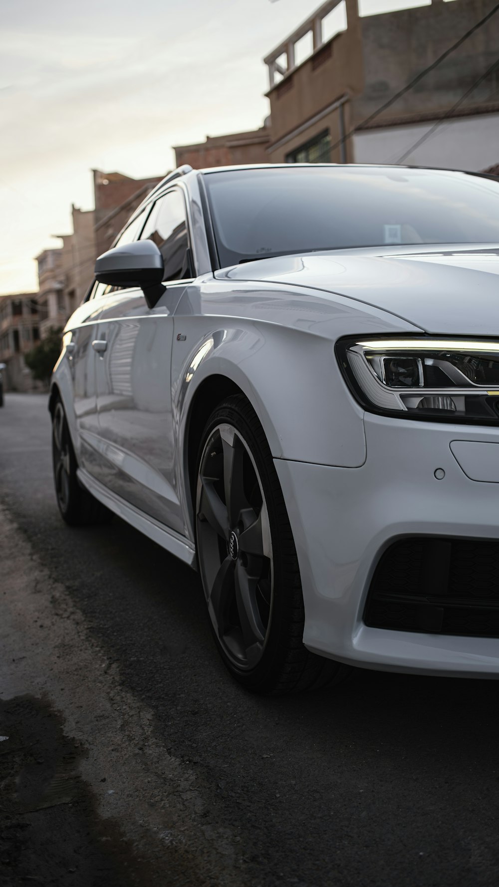 a white car parked on the side of the road