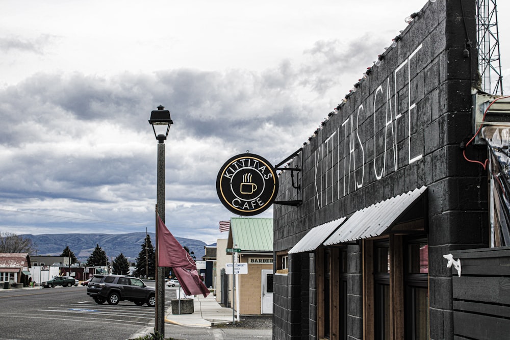 a black building with a clock on the front of it