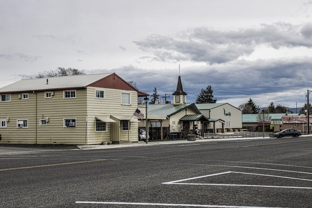 a street with a few buildings and a car parked on the side of the road