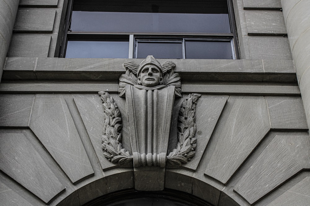 a building with a clock and a statue on the front of it