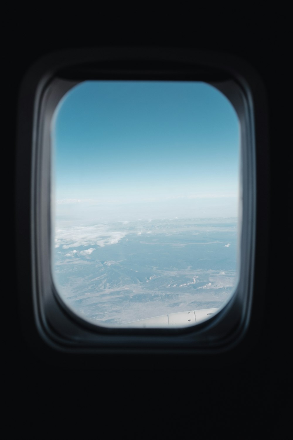 an airplane window with a view of the sky