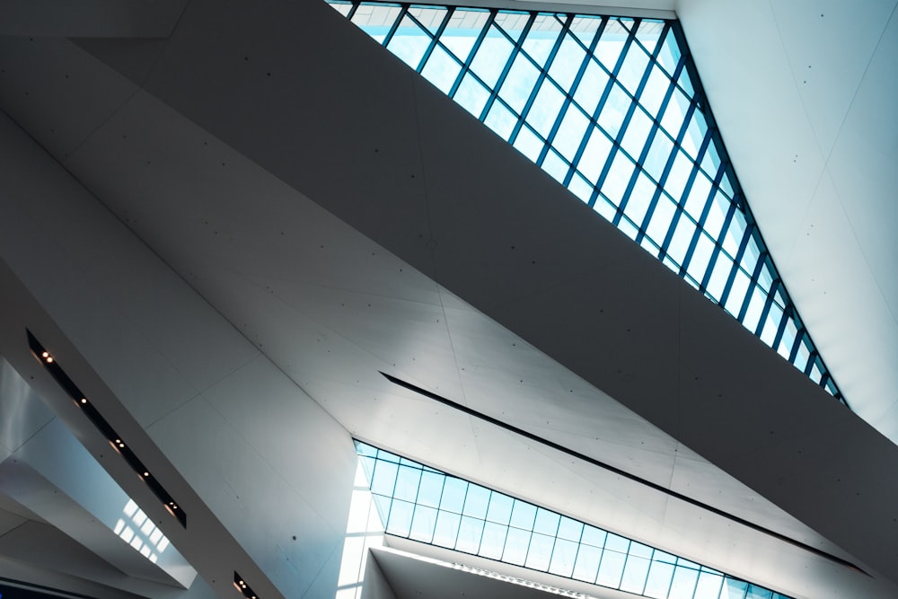 the ceiling of a large building with a lot of windows