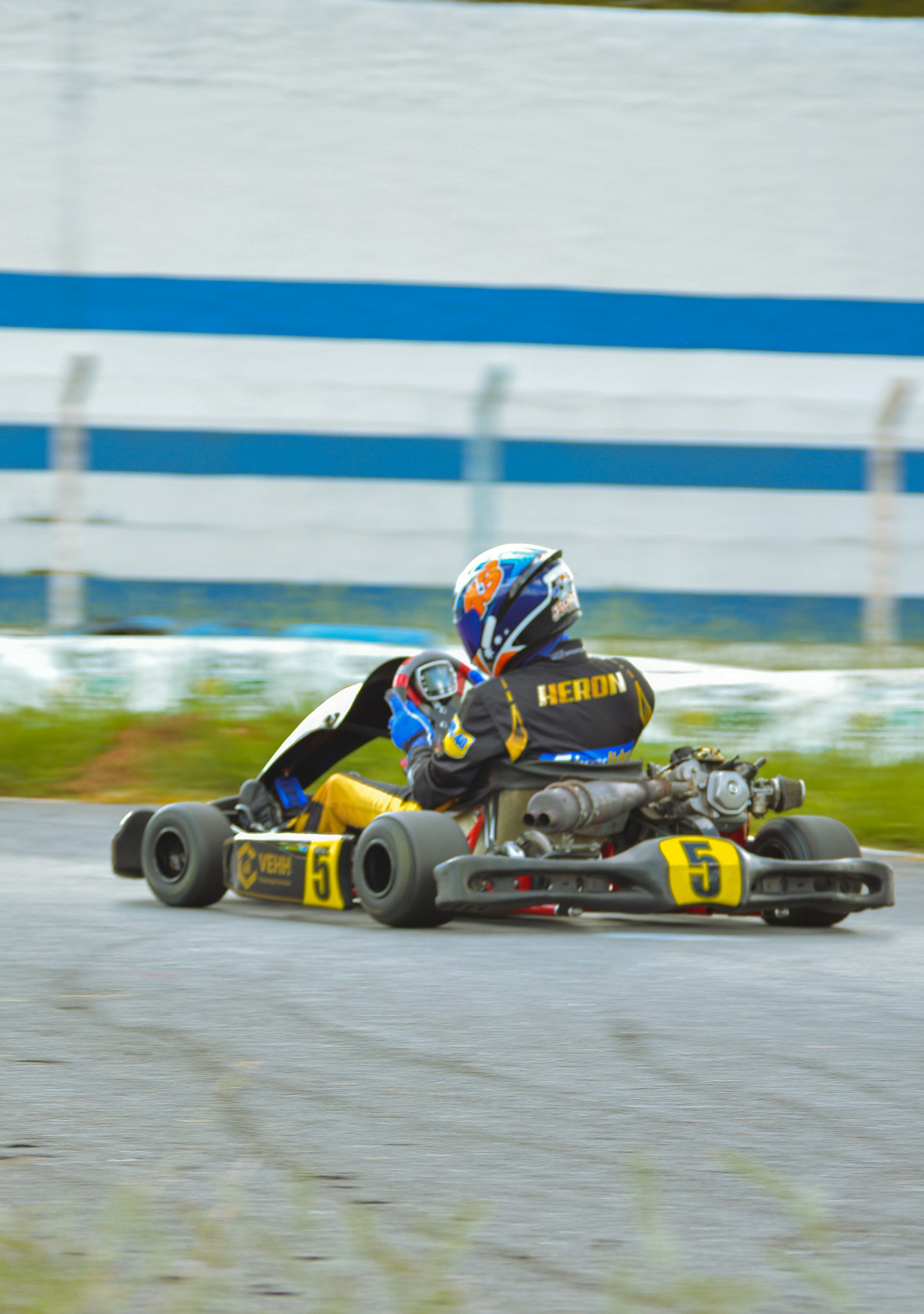 a person riding a go kart on a race track