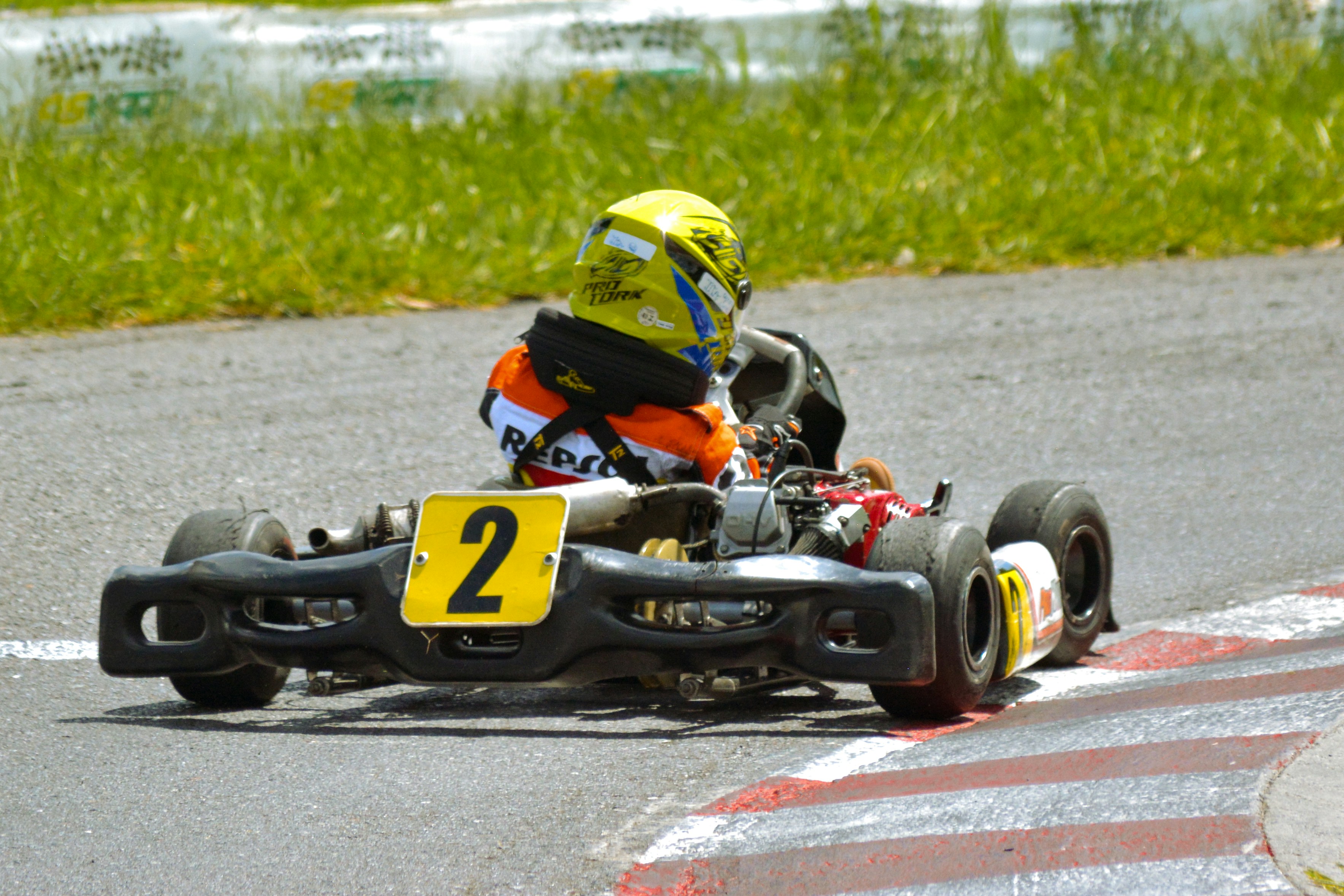 a person riding a go kart on a race track