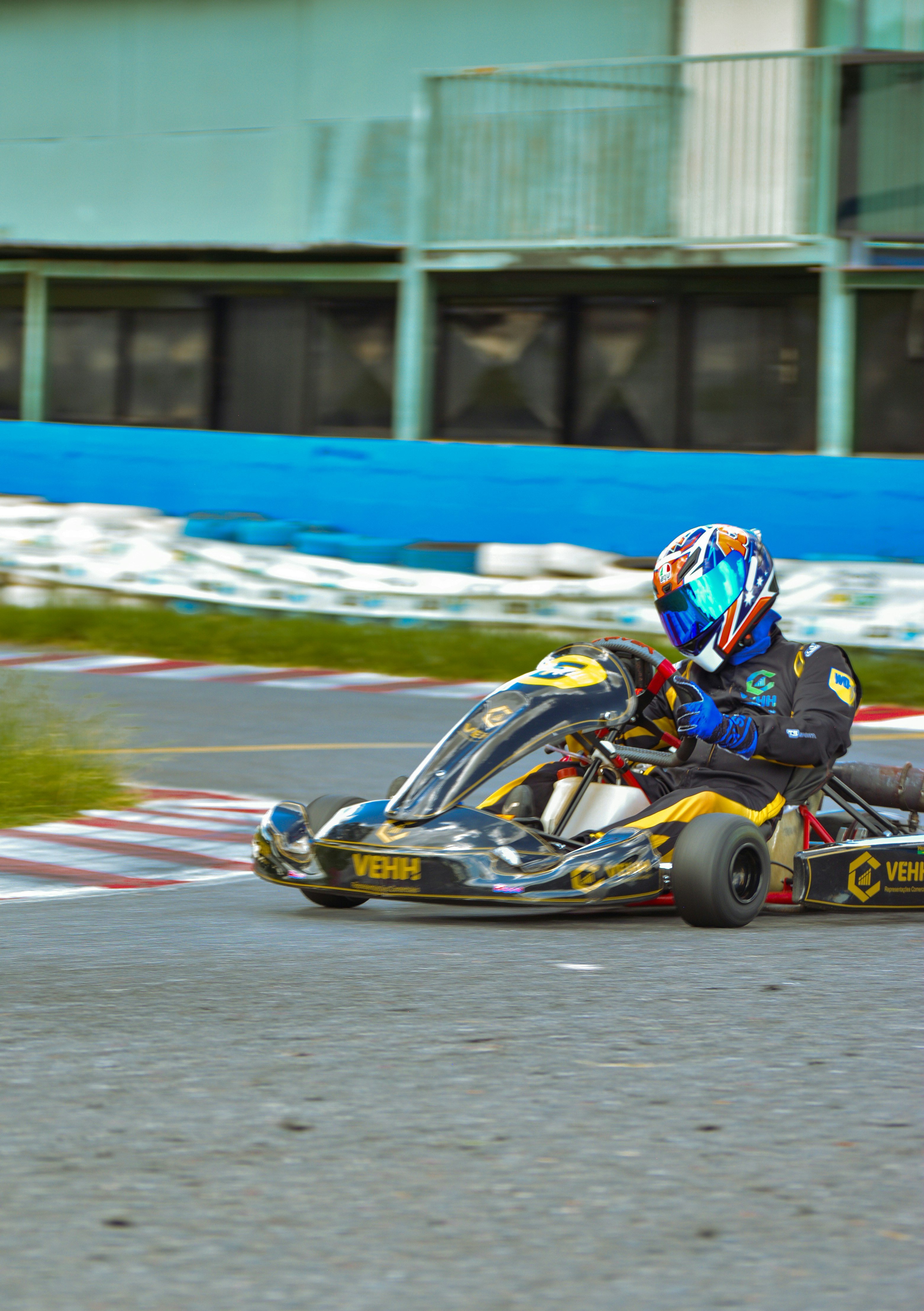a man riding a go kart on top of a race track