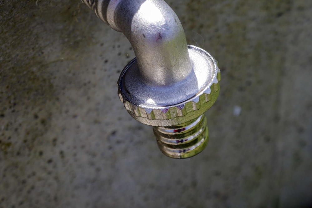 a close up of a metal object on a concrete surface