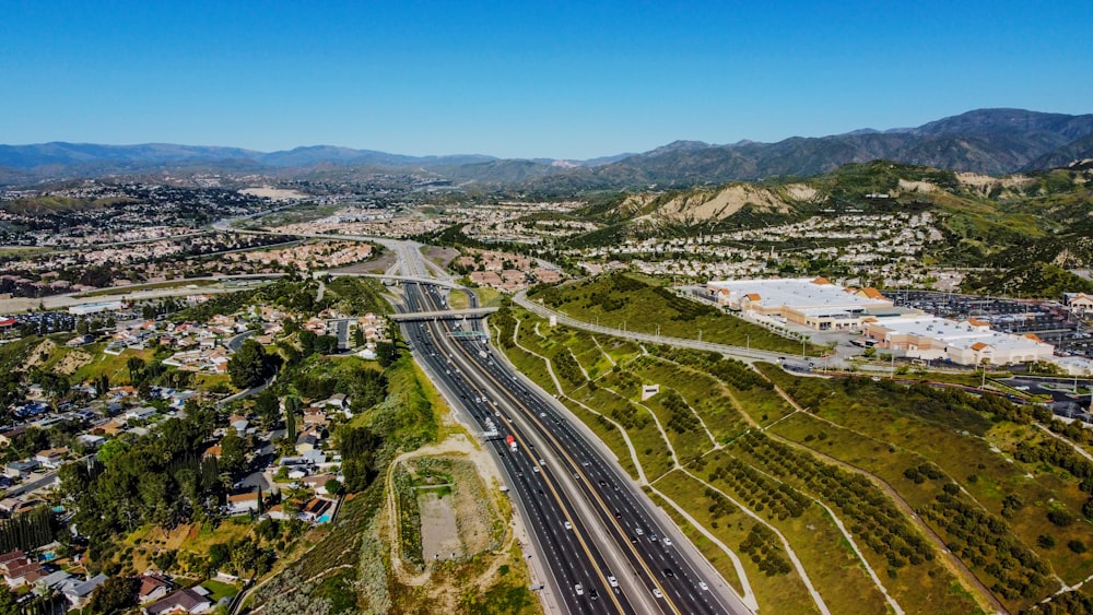 an aerial view of a highway in the mountains