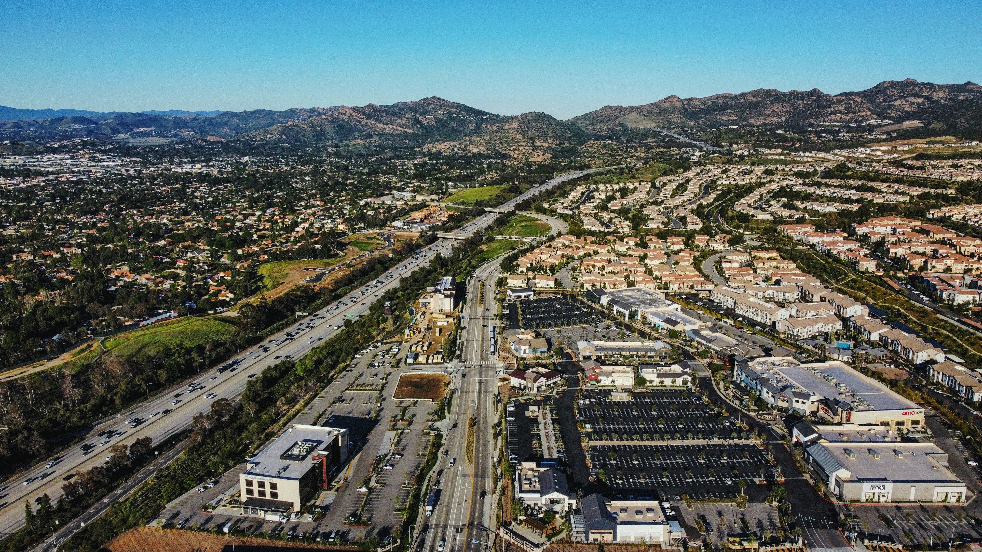 an aerial view of a city with mountains in the background