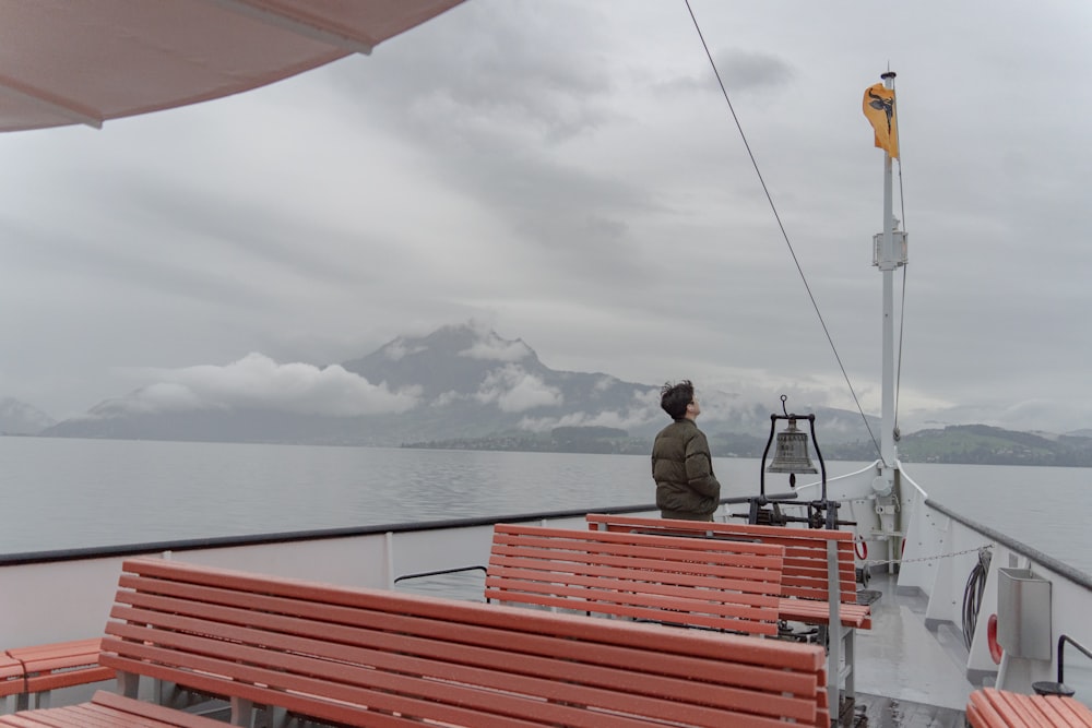 a man sitting on a boat in the water