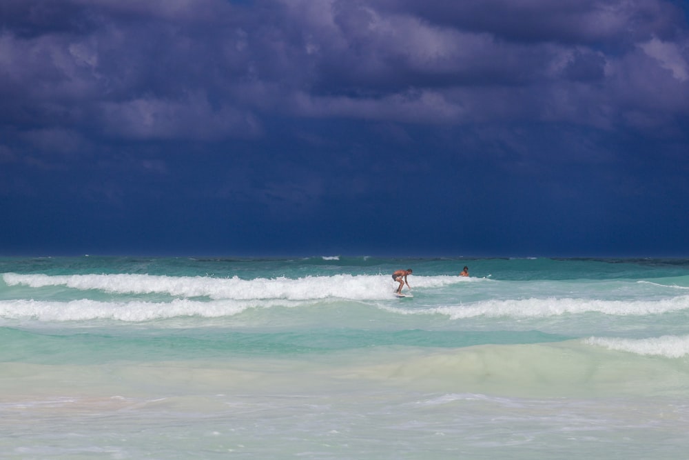 a person riding a surfboard on a wave in the ocean