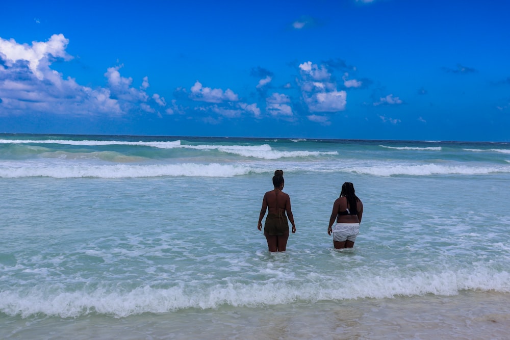 a couple of people that are standing in the water