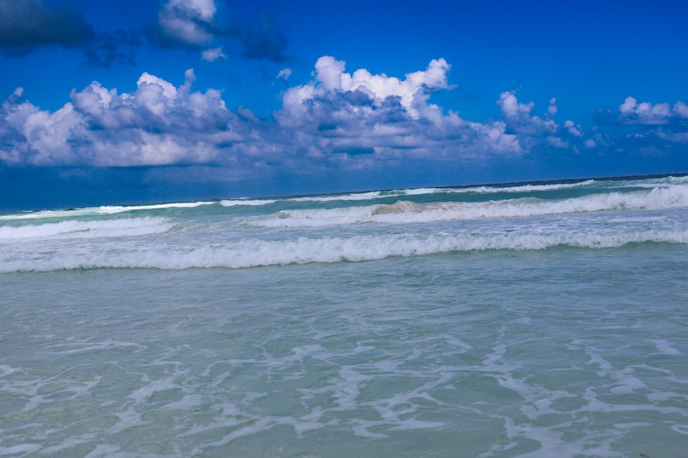 a person riding a surfboard on a wave in the ocean