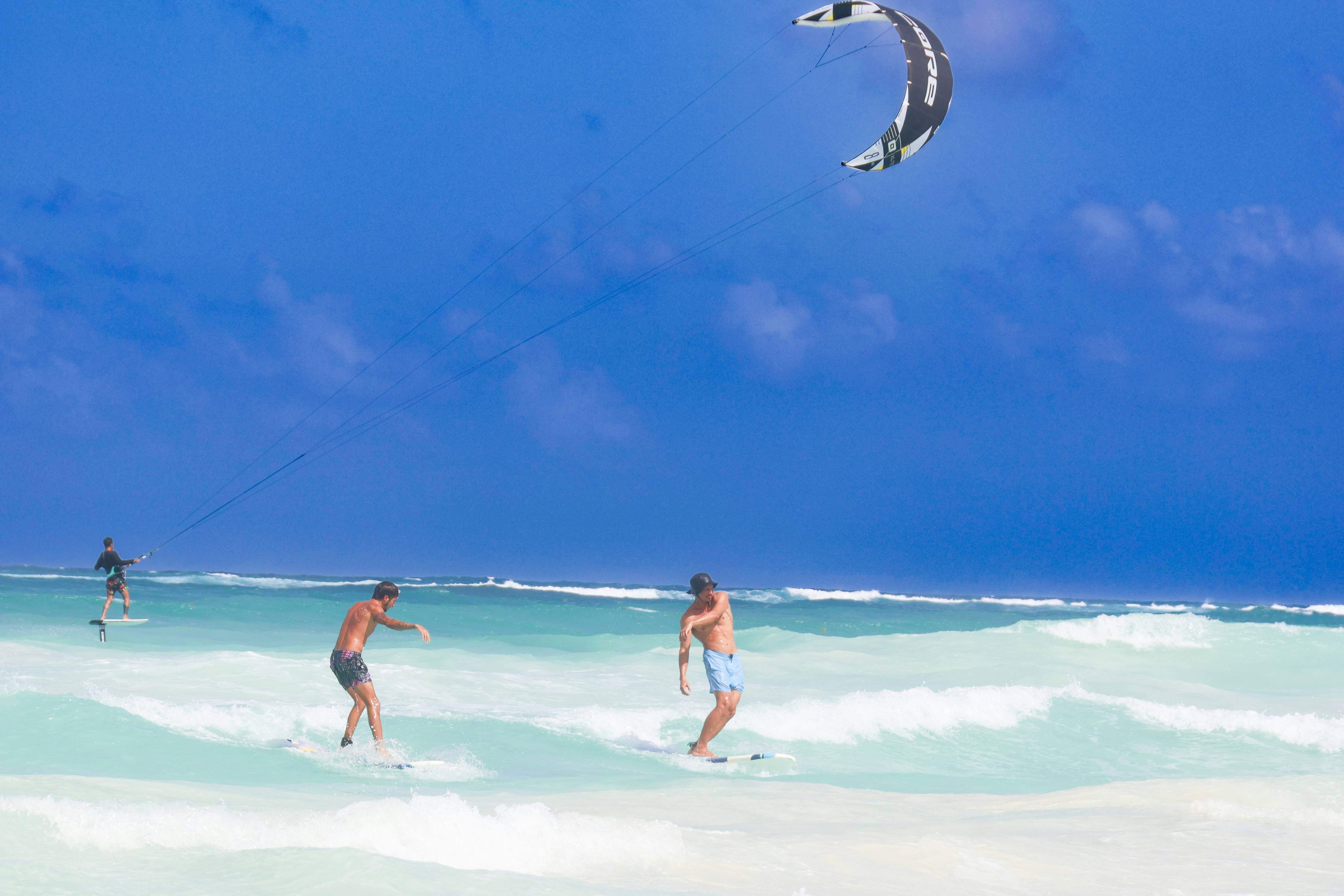 a couple of people that are in the water, 