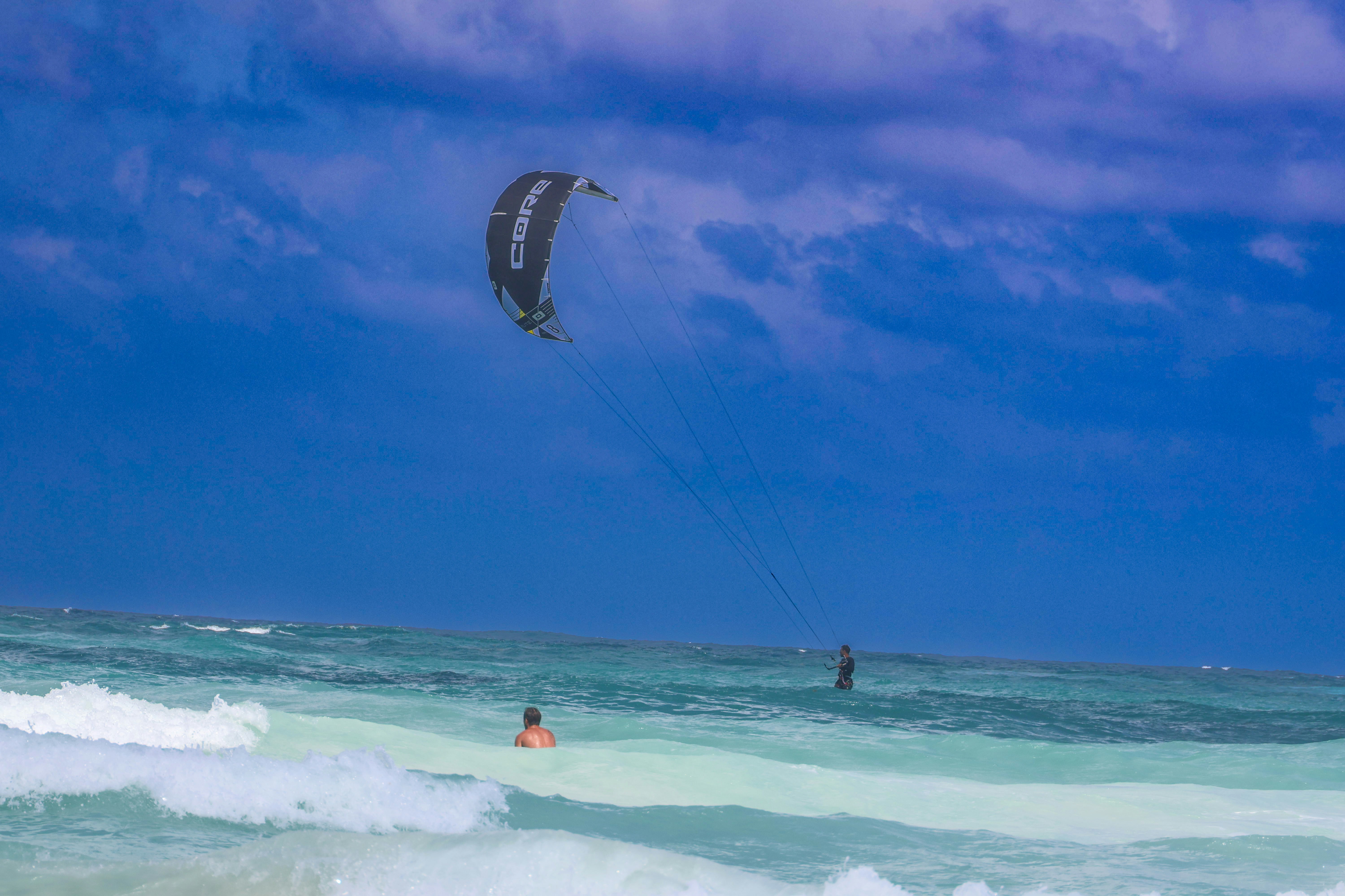 a person para sailing in the ocean on a cloudy day, 