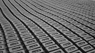 a black and white photo of rows of cell phones