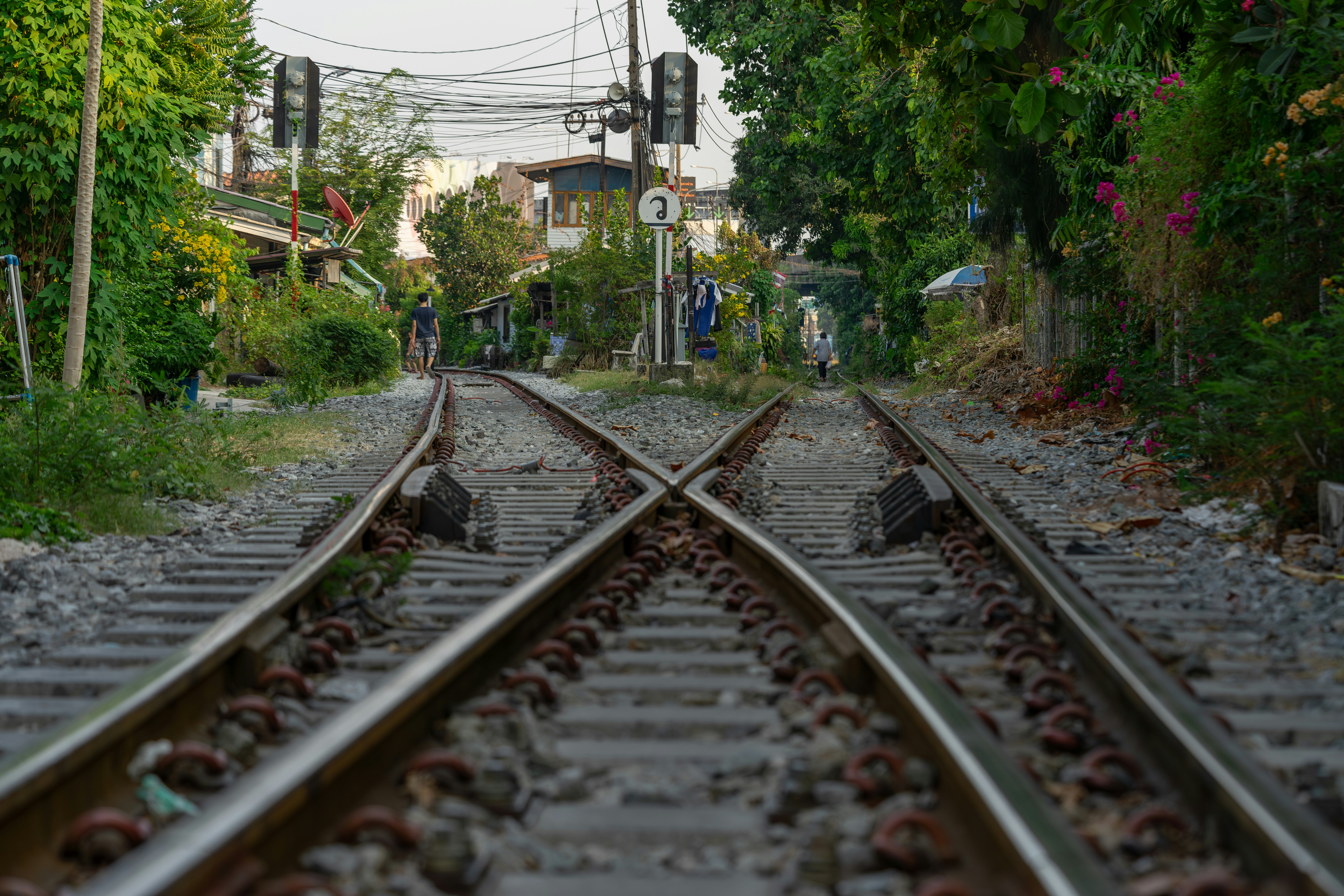 a train track with a person standing on one of the tracks