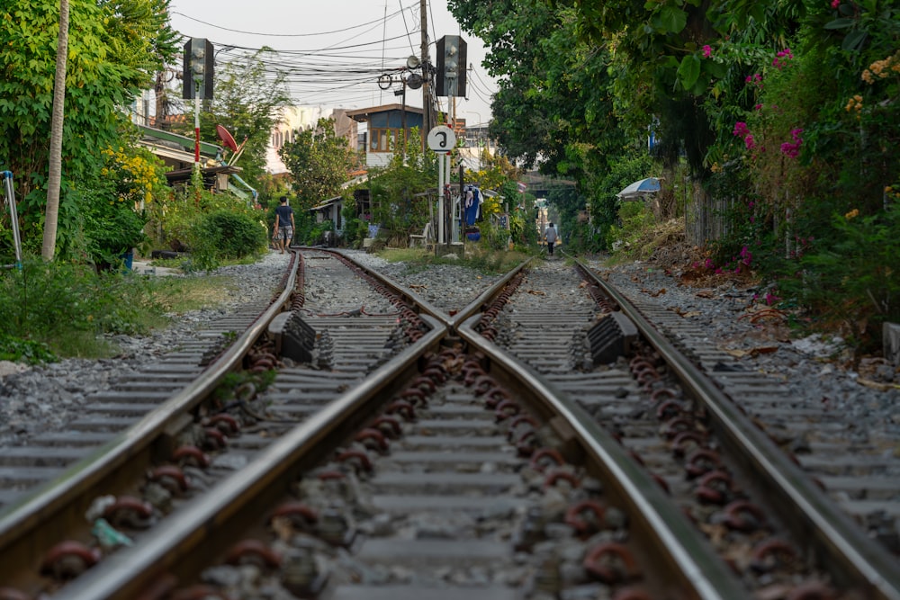 a train track with a person standing on one of the tracks