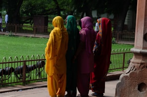 a group of people in colorful outfits standing next to each other