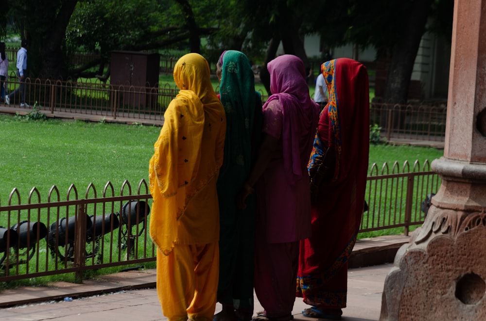 a group of people in colorful outfits standing next to each other