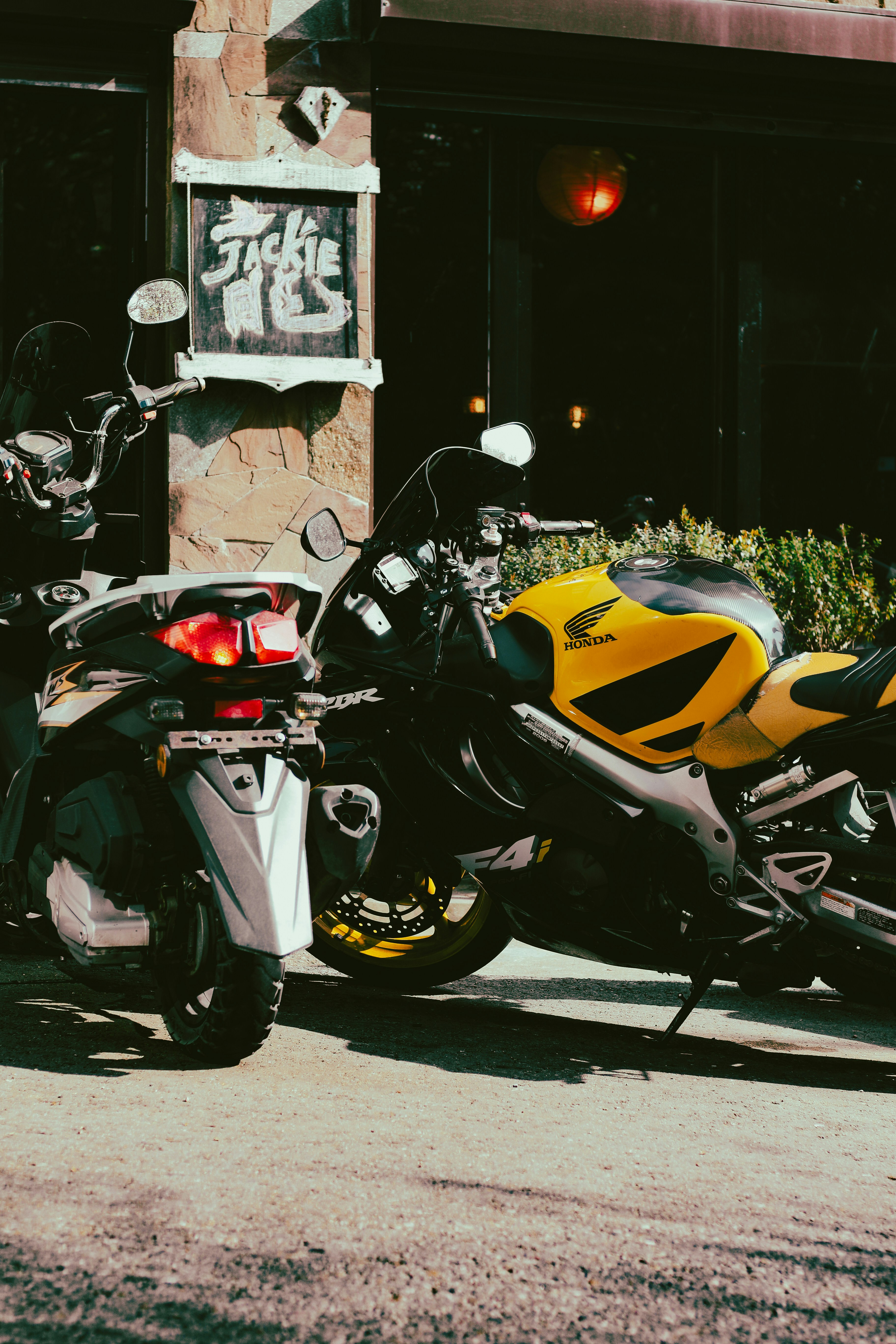 two motorcycles parked next to each other in front of a building