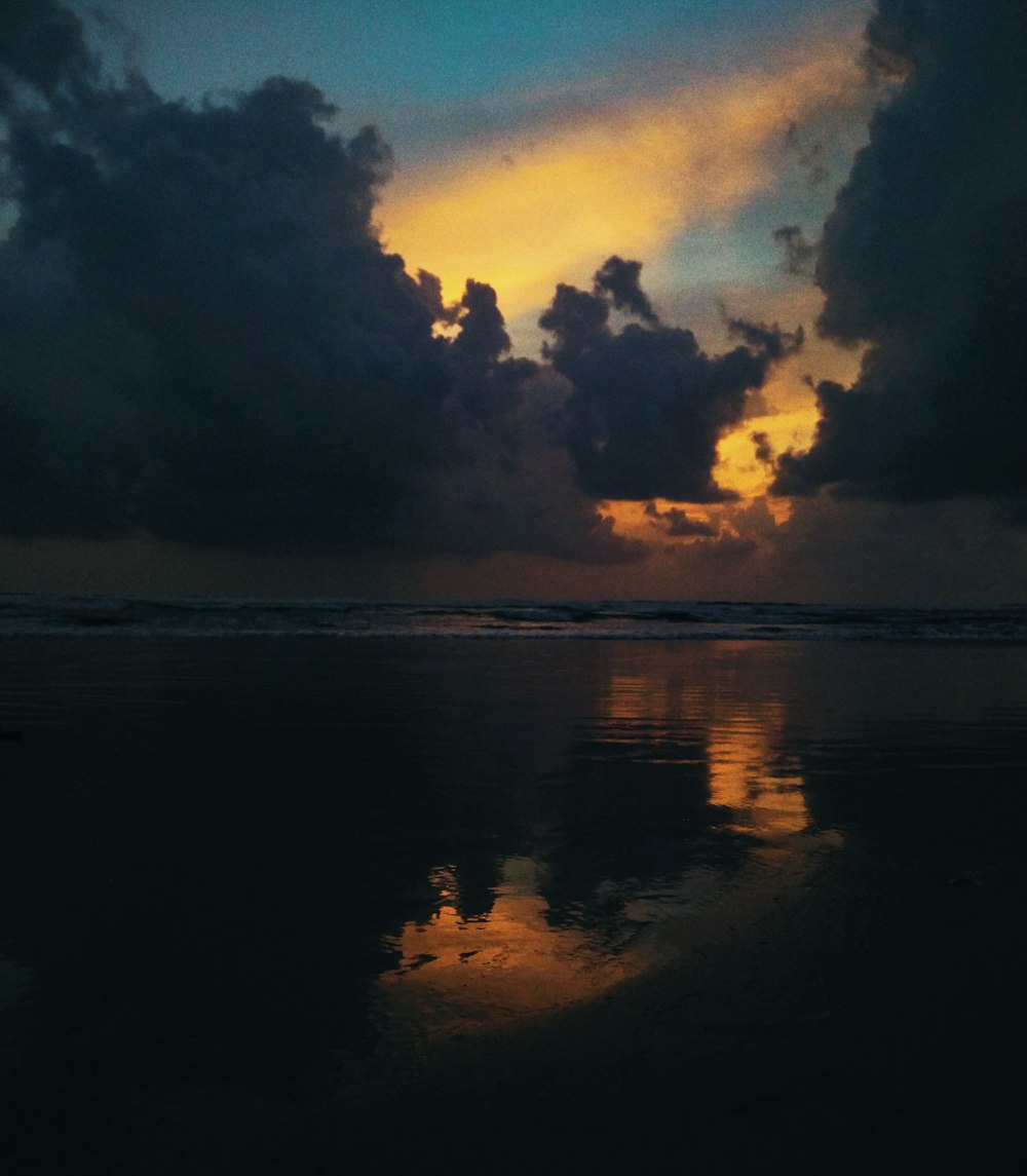 the sky is reflected in the wet sand