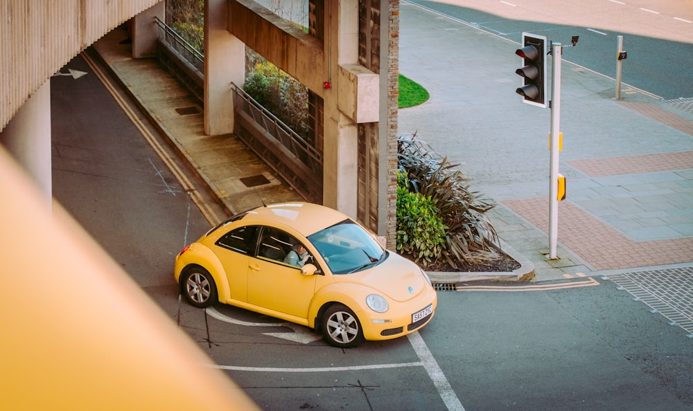 a yellow car is parked on the side of the road