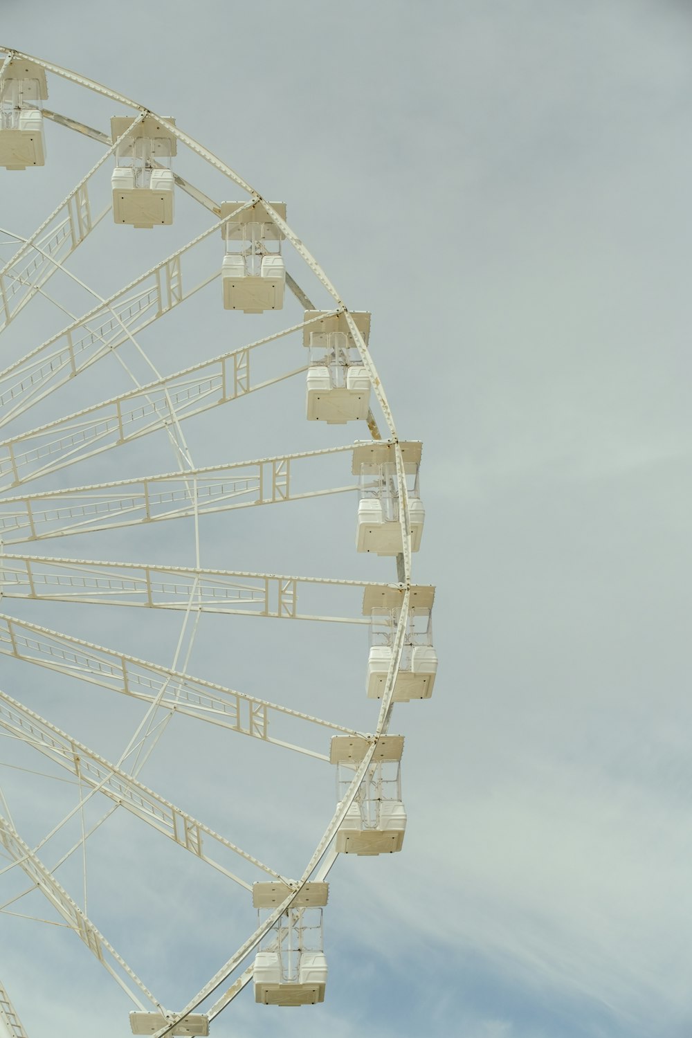 a large white ferris wheel on a cloudy day