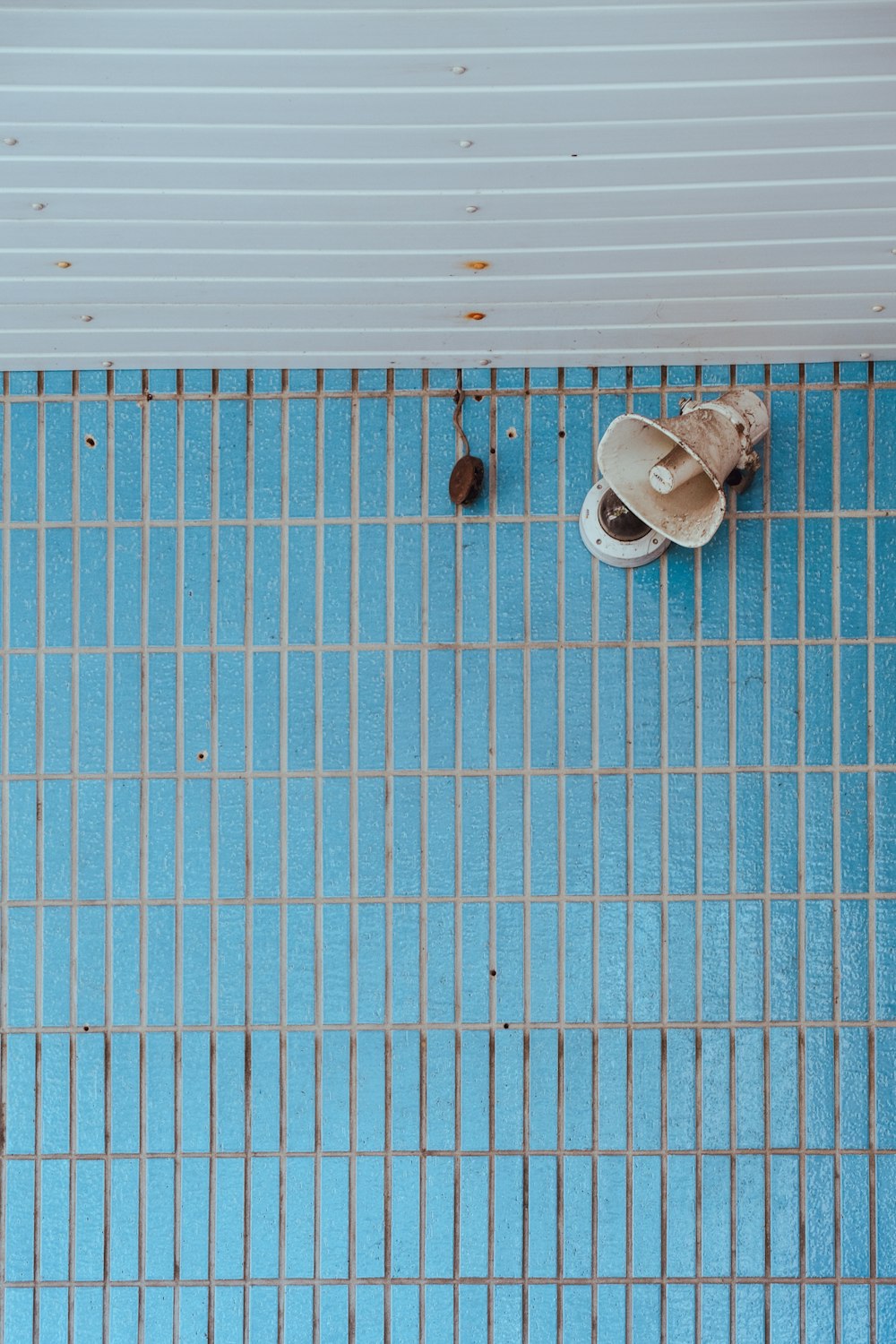 a pair of shoes sitting on top of a blue tiled floor