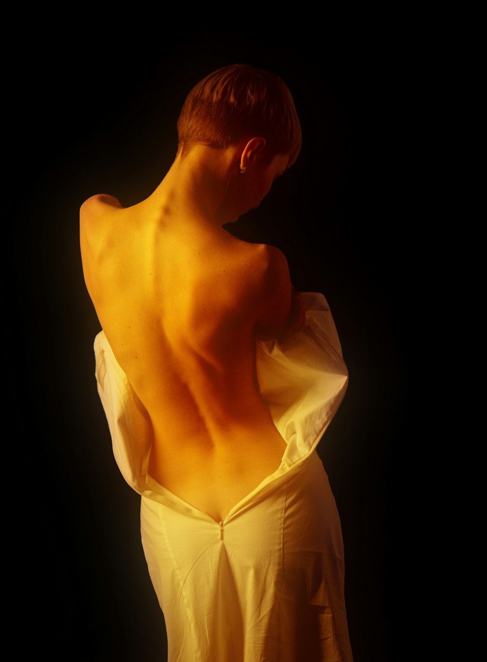 the back of a woman's body in a white dress