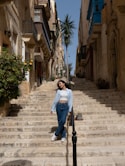 a woman is standing on a set of stairs