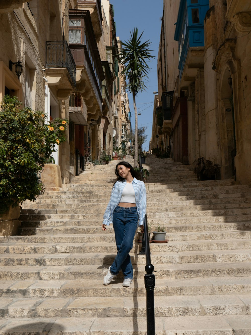 a woman is standing on a set of stairs