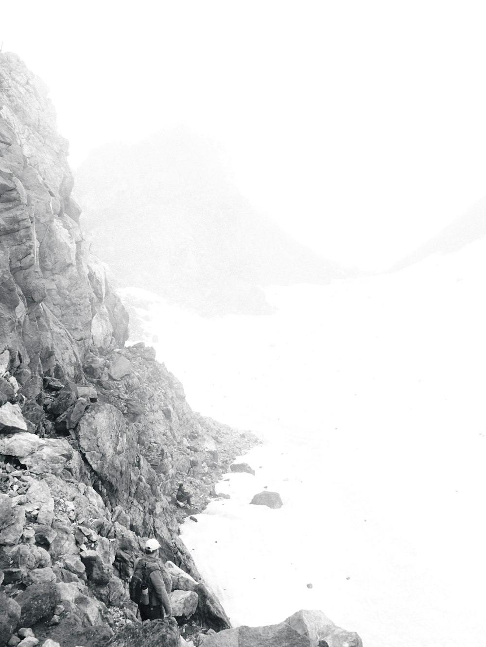 a black and white photo of a mountain side