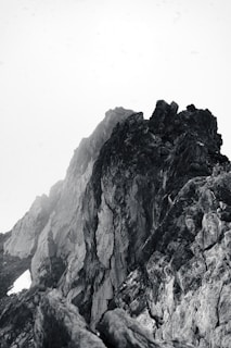 a black and white photo of a mountain peak