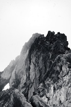a black and white photo of a mountain peak