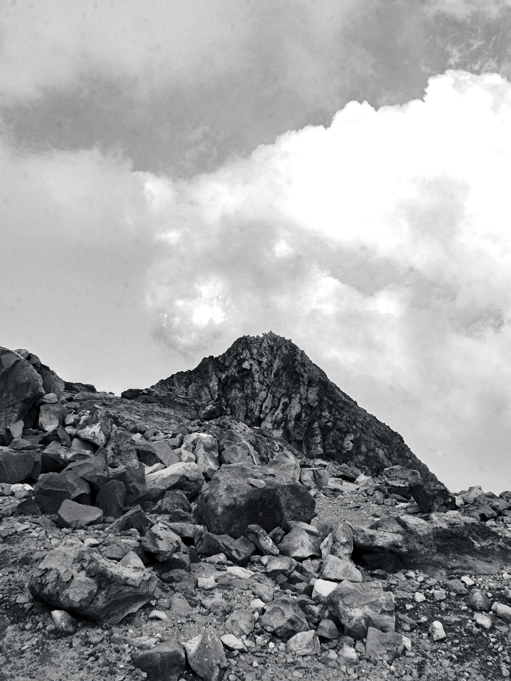 a black and white photo of a rocky mountain