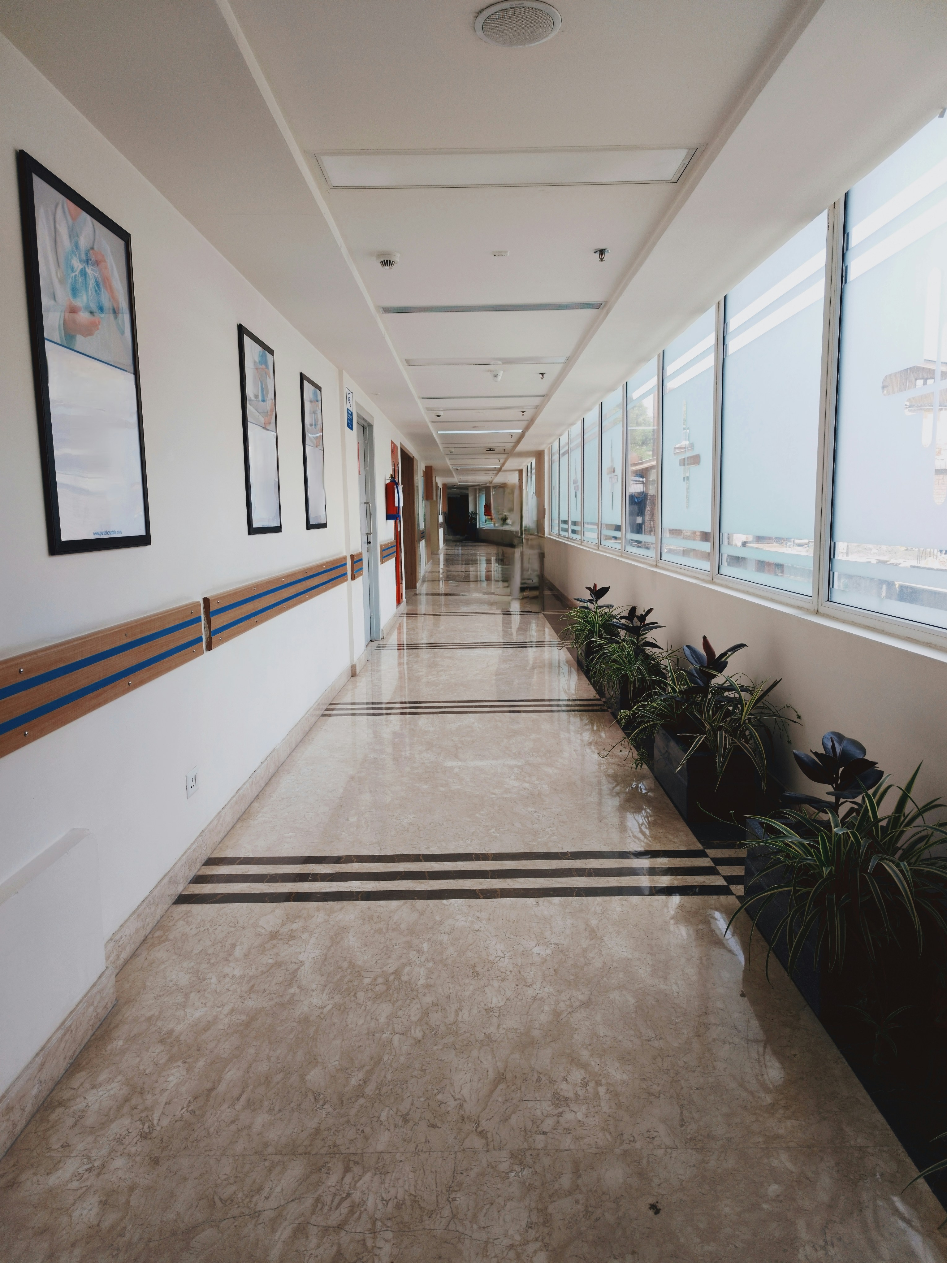 Modern Philippine private hospital lobby with bright natural light, clean white interior