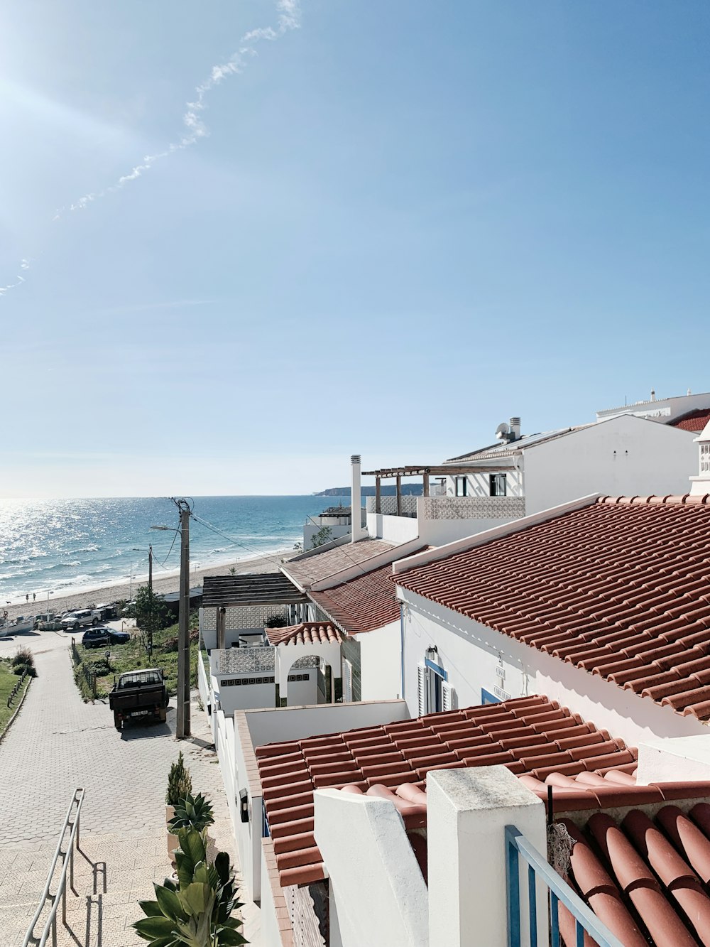 a view of the ocean from a balcony of a house
